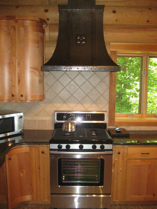 W4231 Wildwood Ln, Moran, MI 49760 - kitchen with stainless steel appliances, custom range hood, and tasteful backsplash