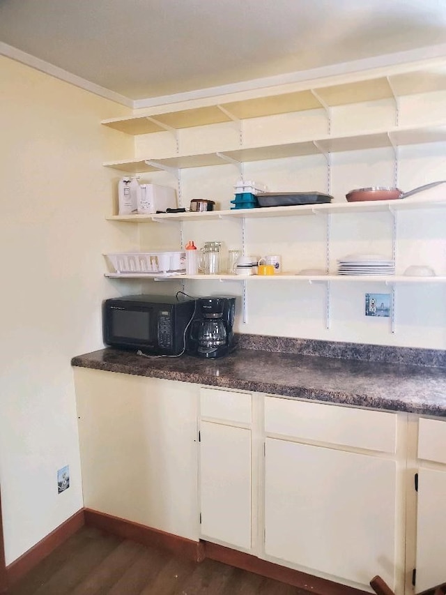 bar featuring white cabinets and dark wood-type flooring