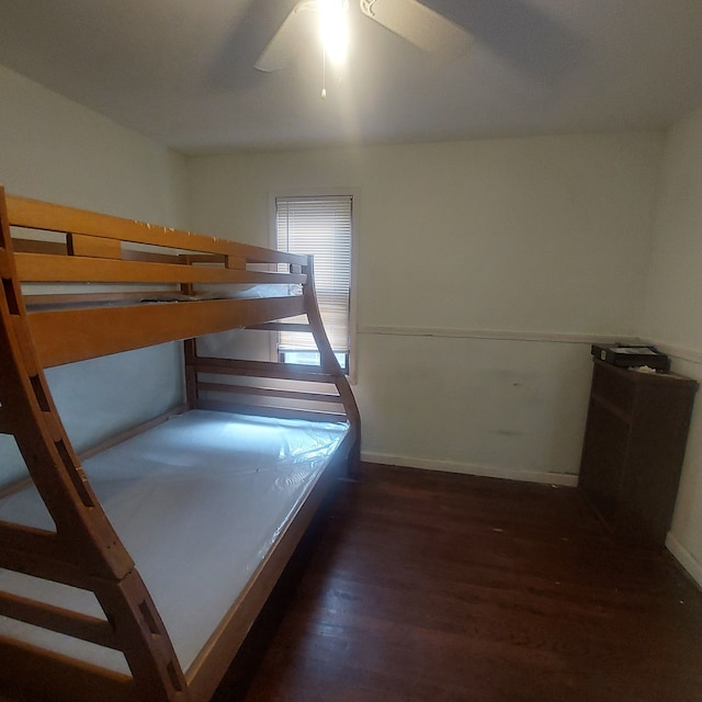 bedroom with ceiling fan and dark hardwood / wood-style floors