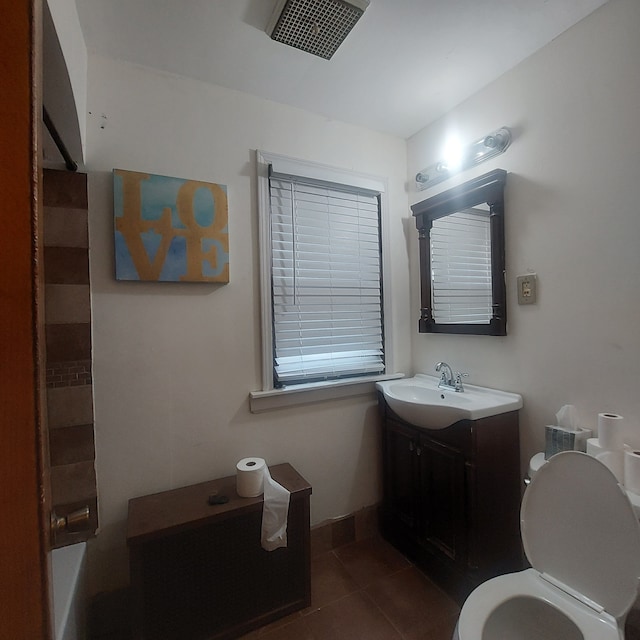 full bathroom featuring tile patterned floors, plus walk in shower, vanity, and toilet