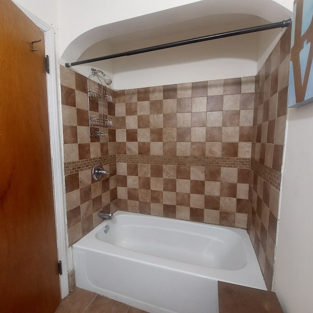 bathroom featuring tile patterned floors and tiled shower / bath combo