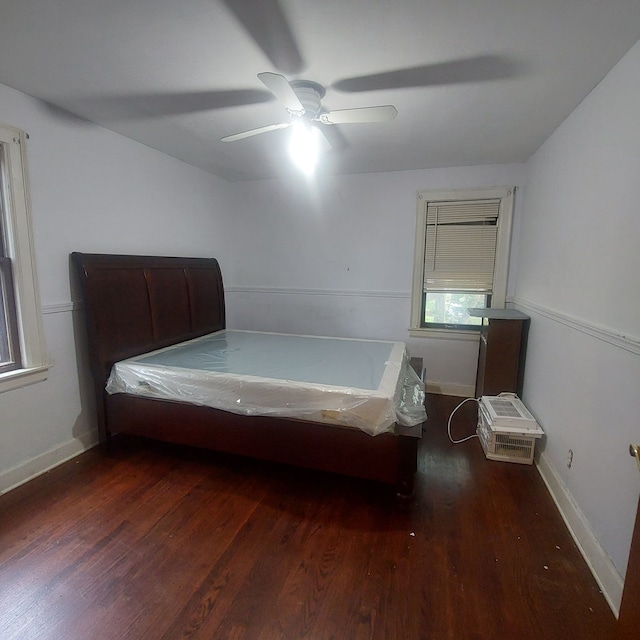 unfurnished bedroom featuring ceiling fan and dark hardwood / wood-style floors