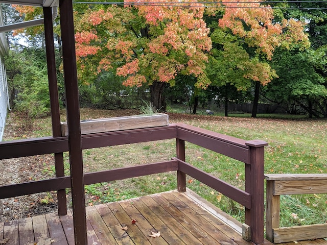 wooden terrace featuring a lawn