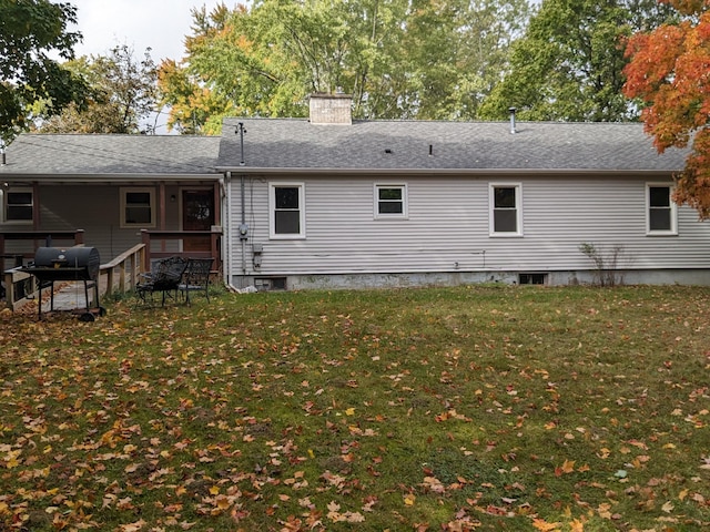 rear view of house with a lawn