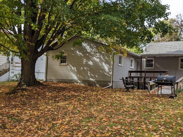 view of property exterior featuring a wooden deck