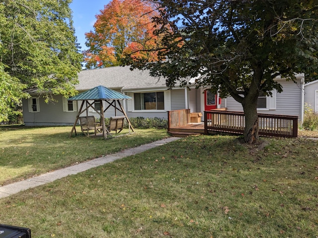 view of front of property with a front yard, a gazebo, and a deck