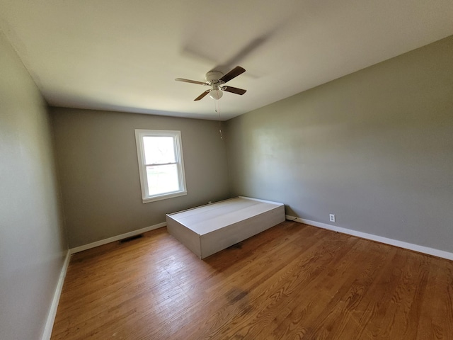 unfurnished bedroom featuring ceiling fan and light hardwood / wood-style floors