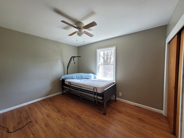 bedroom with ceiling fan and wood-type flooring