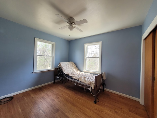 bedroom featuring a closet, hardwood / wood-style flooring, and ceiling fan