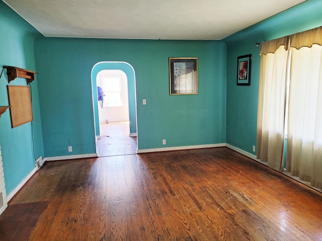 spare room with dark wood-type flooring