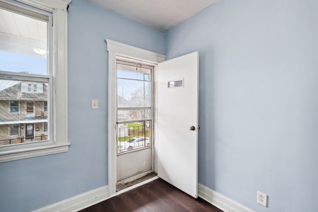 entryway with dark wood-type flooring