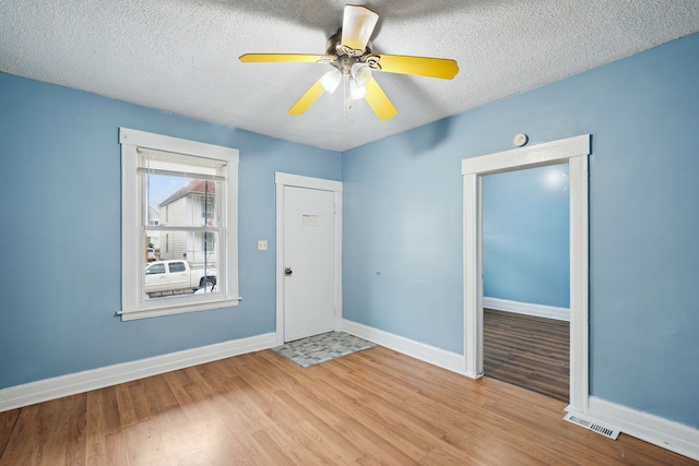 foyer featuring light hardwood / wood-style flooring and a textured ceiling