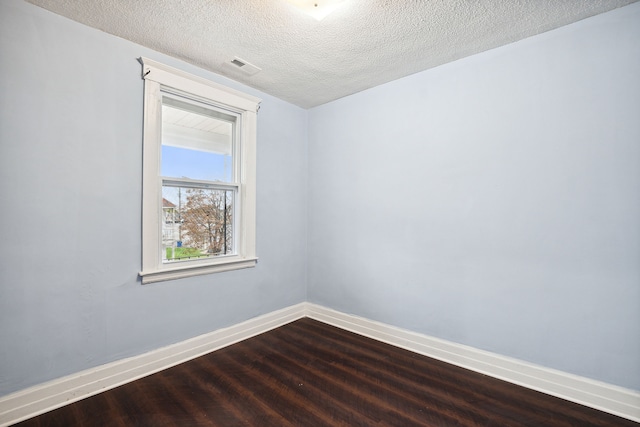 empty room featuring hardwood / wood-style floors and a textured ceiling