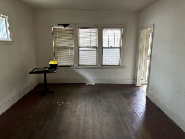 spare room featuring dark wood-type flooring