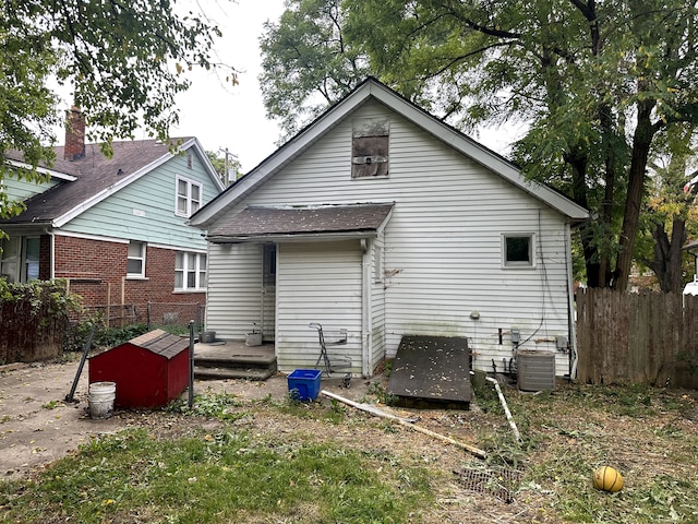 rear view of property featuring central AC