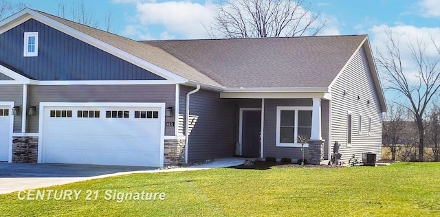 craftsman house with a garage, a front lawn, and central air condition unit