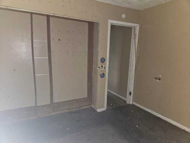 interior space featuring a textured ceiling and a closet