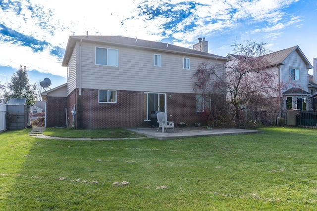 back of house featuring a patio area and a lawn