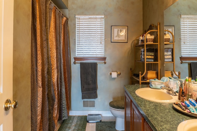 bathroom featuring toilet, a shower with curtain, vanity, and tile patterned floors