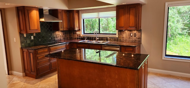 kitchen with a center island, sink, wall chimney exhaust hood, dark stone countertops, and black electric cooktop