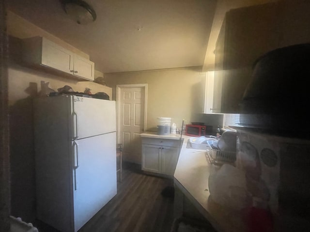 kitchen with white refrigerator, dark hardwood / wood-style floors, white cabinetry, and sink