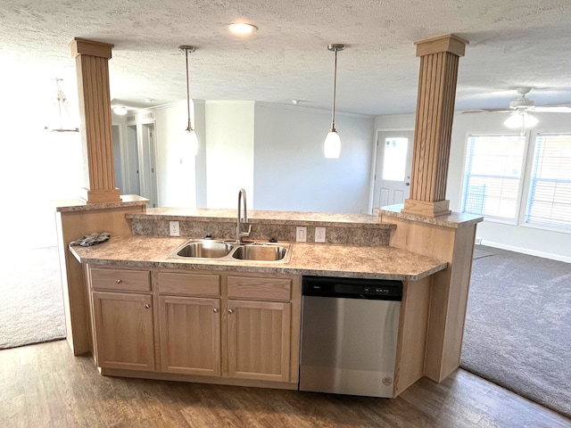 kitchen with dishwasher, decorative columns, and sink