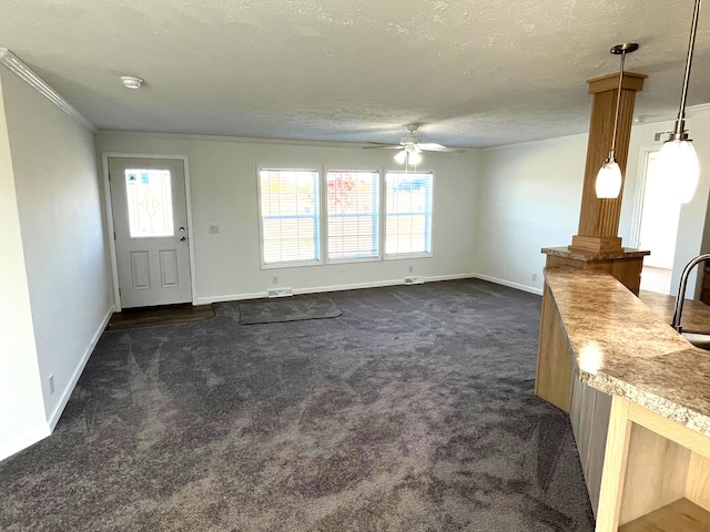 2780 Naples, Lapeer, MI 48446 - unfurnished living room featuring dark carpet, ceiling fan, crown molding, baseboards, and plenty of natural light