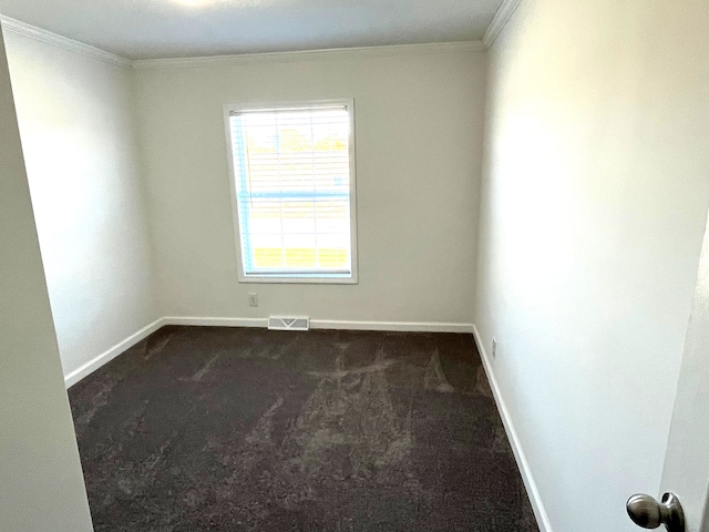 carpeted empty room with crown molding