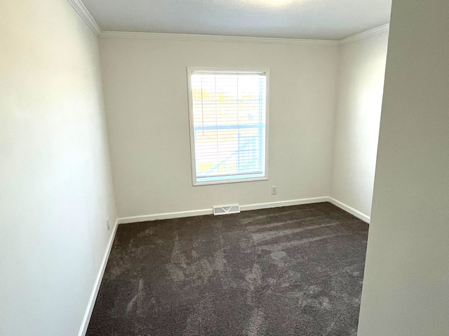 carpeted spare room featuring crown molding