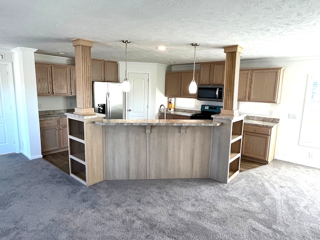 kitchen with hanging light fixtures, a textured ceiling, stainless steel appliances, and a kitchen island with sink