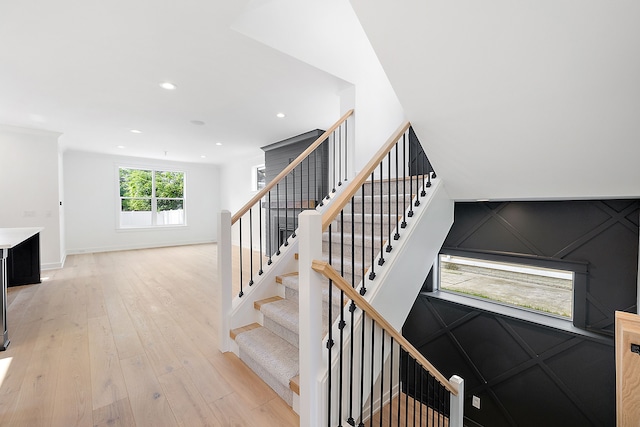 staircase with hardwood / wood-style floors