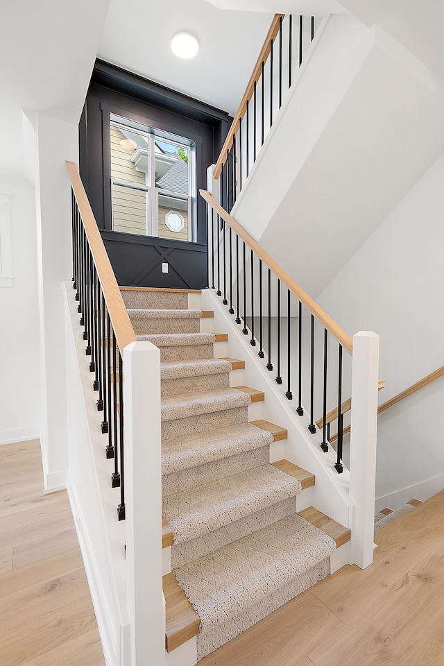 stairway with hardwood / wood-style floors