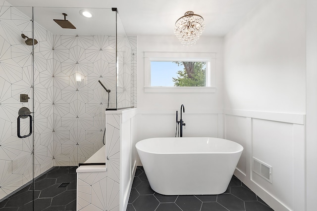 bathroom featuring tile patterned flooring, independent shower and bath, and a notable chandelier