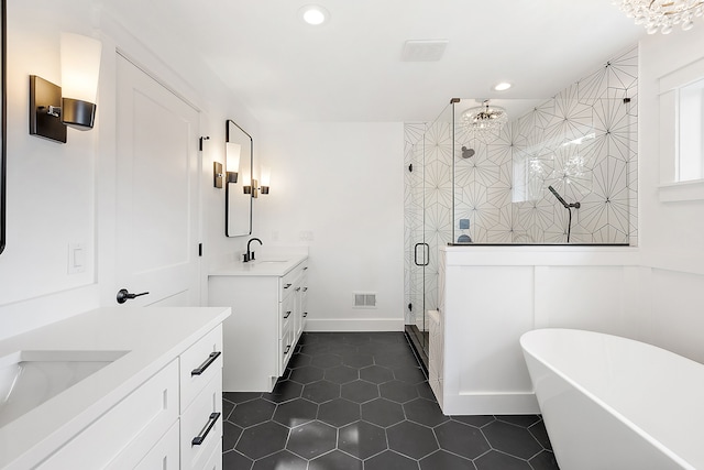 bathroom with tile patterned flooring, shower with separate bathtub, and vanity