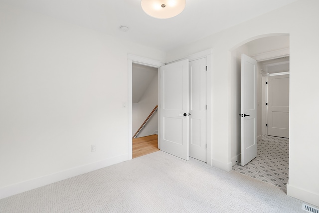 unfurnished bedroom featuring light colored carpet