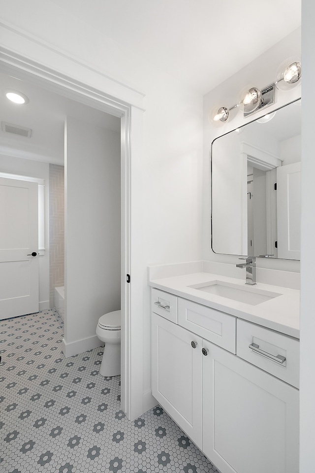 bathroom featuring tile patterned floors, vanity, and toilet