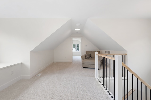 additional living space with lofted ceiling and light carpet