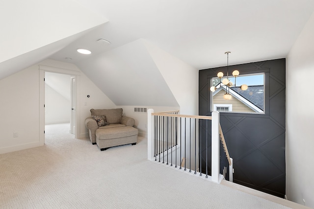 interior space with carpet flooring, a notable chandelier, and lofted ceiling