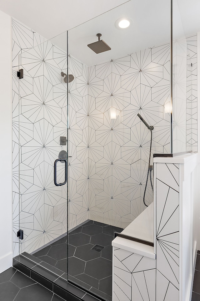 bathroom featuring tile patterned flooring, walk in shower, and tile walls