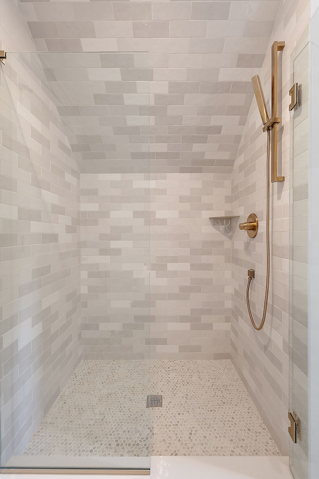 bathroom with a shower with door