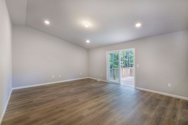 empty room featuring dark hardwood / wood-style floors and lofted ceiling