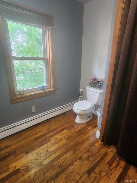 6000 N Dort Hwy, Flint, MI 48505 - bathroom with toilet, wood finished floors, and a baseboard heating unit