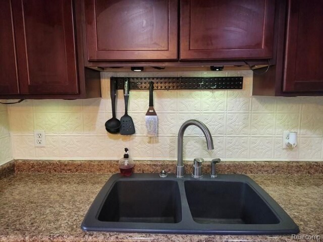 6000 N Dort Hwy, Flint, MI 48505 - kitchen view of a sink, reddish brown cabinets, and decorative backsplash