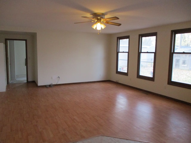 spare room with wood-type flooring and ceiling fan