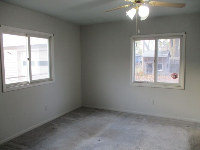 unfurnished room with light colored carpet and ceiling fan