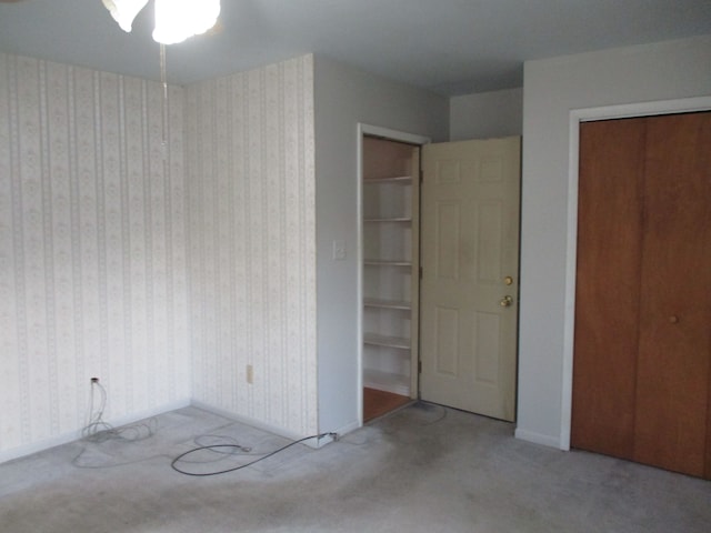 unfurnished bedroom featuring light carpet