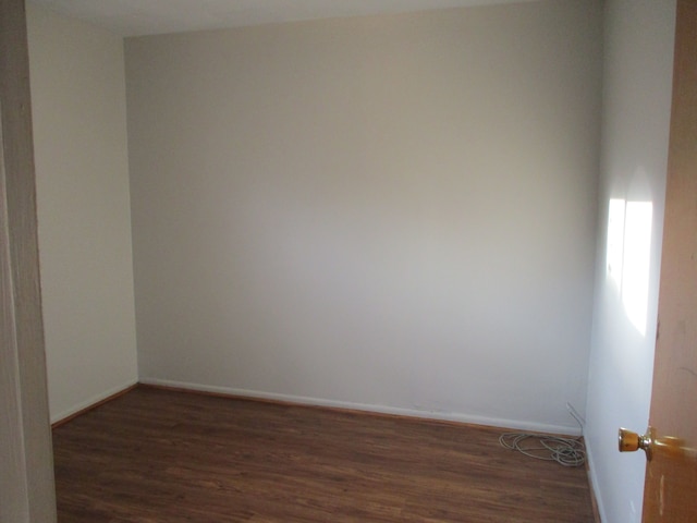 spare room featuring dark hardwood / wood-style floors