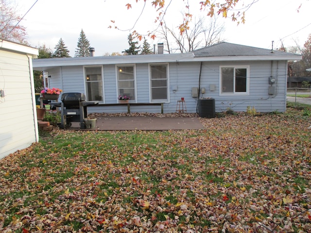 back of property featuring a yard, central AC unit, and a wooden deck