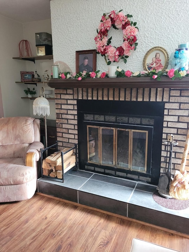 room details featuring a fireplace and wood-type flooring