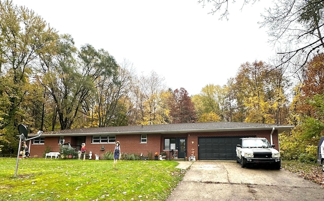 single story home featuring a garage and a front yard